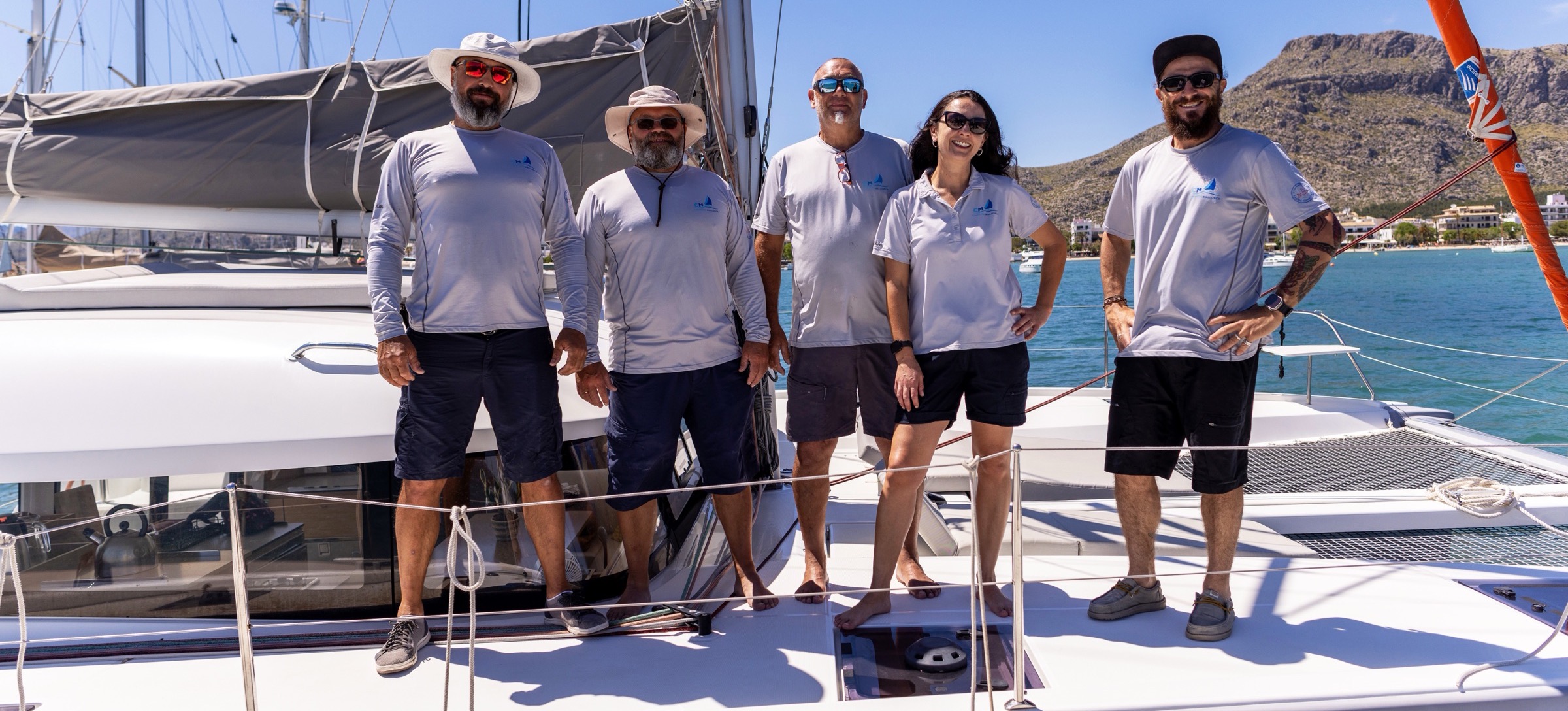 The CM Charter team on a catamaran in Port de Pollença